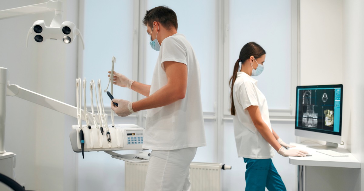 a dentist and dental nurse working in a surgery